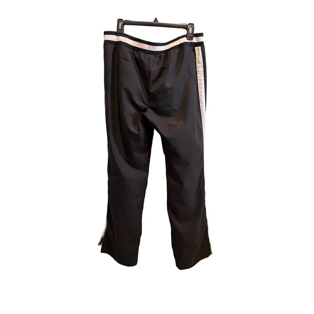 Nike black track pants with white side stripes and ankle zippers - L